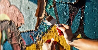 Manos restauran murales con colores vibrantes