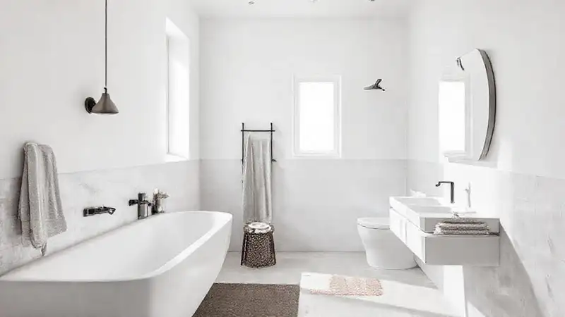 Un baño minimalista blanco, elegante y limpio
